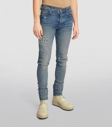 AMIRI Distressed Logo Skinny Jeans