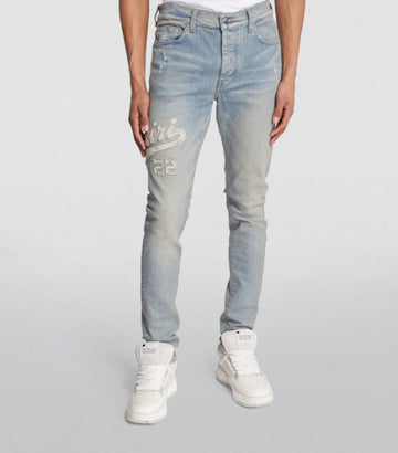 AMIRI  Logo Varsity Skinny Jeans